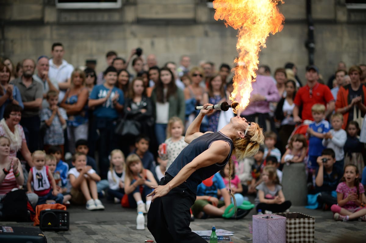 A street entertainer performs on Edinburgh's Royal Mile during the city's Festival Fringe. Scotland. (Jeff J Mitchell/Getty Images)